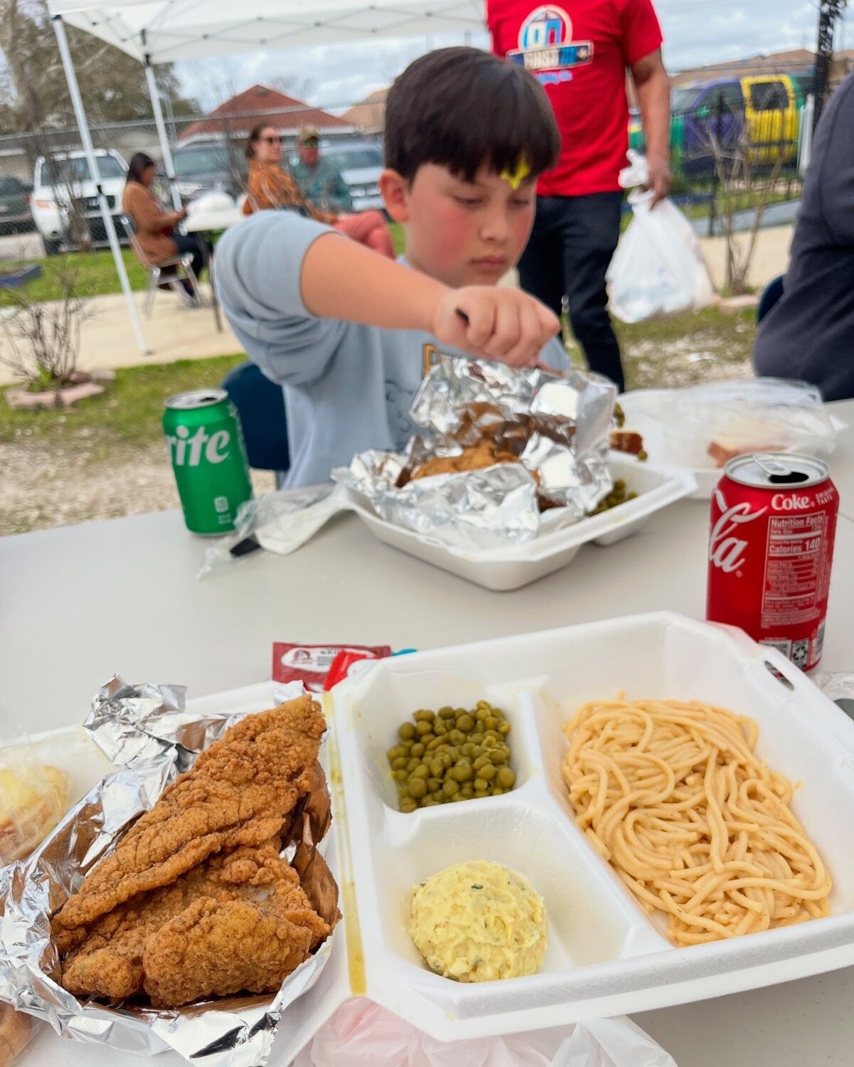 Boy eating a fish plate in New Orleans