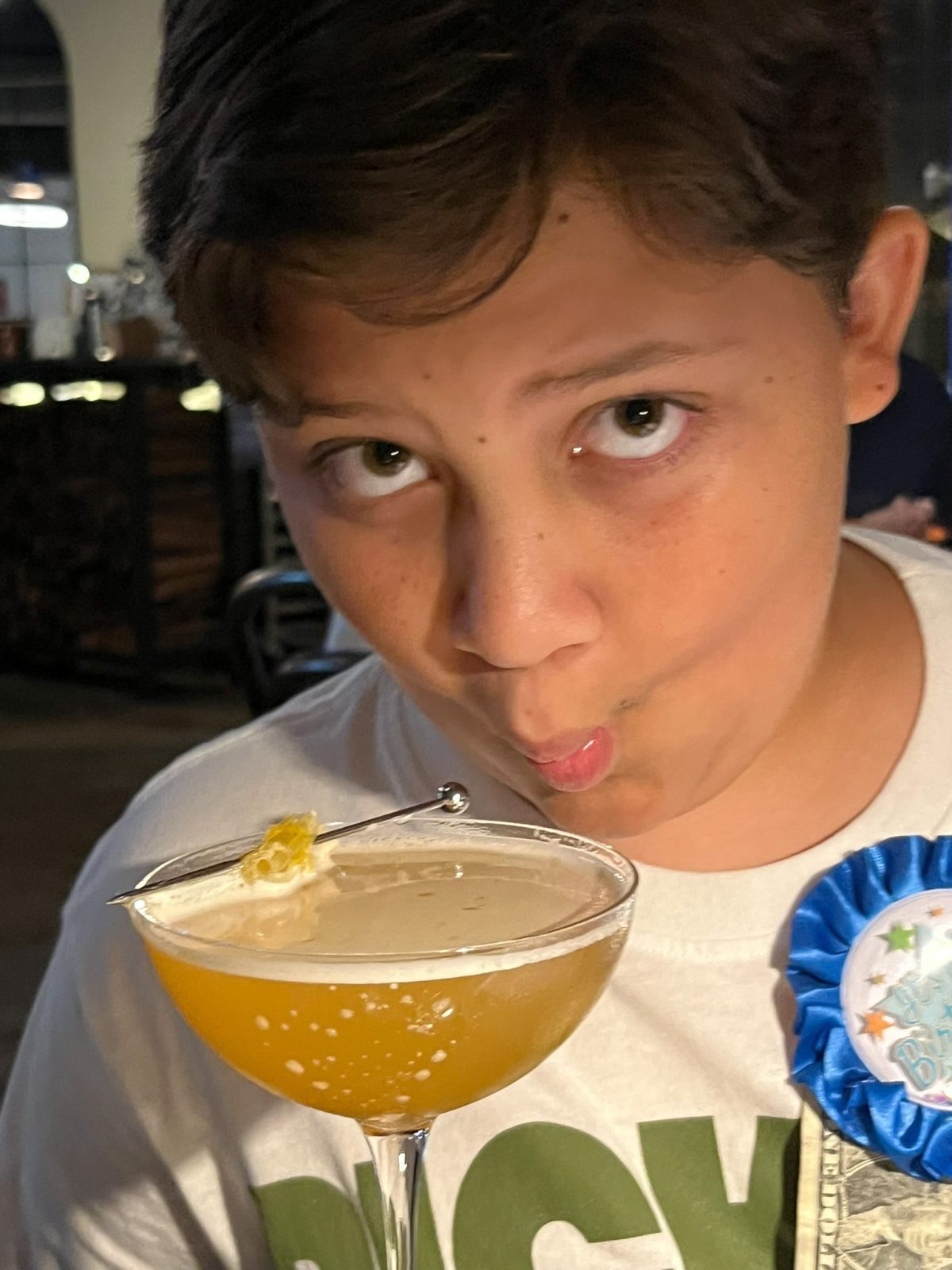 Franklin celebrating his 12th birthday with a Bee's Knees mocktail at Dolfy's in New Orleans on Freret Street